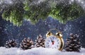 Christmas or New Year background with Golden alarm clock in snowdrifts on blue background with pine cones, fir tree, holiday Royalty Free Stock Photo