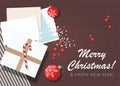 Christmas or New Year background. Present box, red christmas balls, wrapped paper, envelope wiht postcard on table. Royalty Free Stock Photo