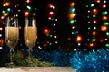 Christmas and New Year background. Romantic dinner of a couple in love with two glasses of champagne. Blue tinsel and spruce branc Royalty Free Stock Photo