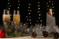 Christmas and New Year background. Romantic dinner of a couple in love with two glasses of champagne. Silver tinsel and spruce. Royalty Free Stock Photo