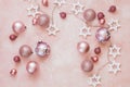 Shiny baubles and string on rustic pink background