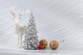 Christmas or New Year background with silver snowy tree and golden transitional decoration, deer Royalty Free Stock Photo