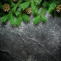 Christmas and New Year background. Christmas tree branch on a black background. Cones and fur-tree toys. View from above. Royalty Free Stock Photo