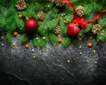 Christmas and New Year background. Christmas tree branch on a black background. Cones and fur-tree toys. View from above. Royalty Free Stock Photo