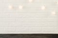 White brick wall with Christmas lights in the form of white balls Royalty Free Stock Photo