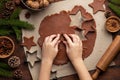 Christmas and New Year bakery. Close up of kids hands cooking traditional gingerbread cookies