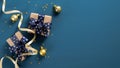 Christmas and New Year banner mockup. Gift boxes with ribbon bow and golden decorations over blue background. Flat lay, top view, Royalty Free Stock Photo