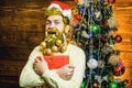 Christmas or New Year barbershop concept. Beard with bauble. Santa in barber shop. Christmas style for modern Santa. Royalty Free Stock Photo