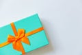 Christmas New Year birthday valentine celebration present romantic concept. Simply minimal design blue gift box with orange ribbon Royalty Free Stock Photo
