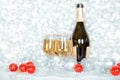 Christmas or New Year bottle of champagne, two full glasses of champagne on table, shiny and sparkling Christmas tree balls Royalty Free Stock Photo