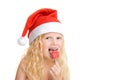 Christmas and new year card with cute little blonde girl in red santa claus hat with lollipop looking at camera close-up isolated Royalty Free Stock Photo