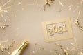 Christmas and New Year card with golden champagne bottle, confetti stars and 2021 numbers Royalty Free Stock Photo