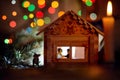 Christmas and New Year card: toy winter house at night with two lego people