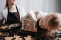 Mother and daughter decorating gingerbread house Royalty Free Stock Photo