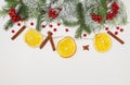 Christmas or New Year composition, background with spruce branches, red berries, citrus, cinnamon on a white background. Card