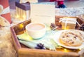 Christmas and New Year composition. Cocoa, cookies, little giftbox and postcard on the wooden tray with xmas background. Sweets