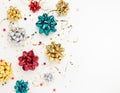 Christmas or New Year composition with colored sparkling ribbon decorations on white background. Flat lay, copy space Royalty Free Stock Photo