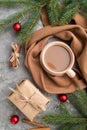 Christmas or New Year composition. Decorations, fir and spruce branches, cup of coffee, on a gray concrete background. Top view Royalty Free Stock Photo