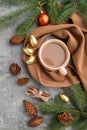 Christmas or New Year composition. Decorations, cones, fir and spruce branches, cup of coffee, on a gray concrete background. Top Royalty Free Stock Photo