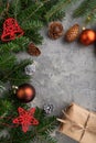 Christmas or New Year composition. Decorations, cones, fir and spruce branches, cup of coffee, on a gray concrete background. Top Royalty Free Stock Photo