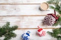 Christmas or New Year composition. Decorations, knitted balls, fir and spruce branches, on a white wooden background. Top view, Royalty Free Stock Photo