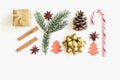 Christmas and New Year composition. Gift box with ribbon, fir branches, cones, star anise, cinnamon, candy cane and paper christma Royalty Free Stock Photo