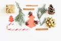 Christmas and New Year composition. Gift box with ribbon, fir branches, cones, star anise, cinnamon, candy cane and paper christma Royalty Free Stock Photo