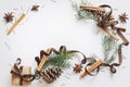 Christmas and New Year composition. Gift box with ribbon, fir branches with cones, star anise, cinnamon on white background Royalty Free Stock Photo