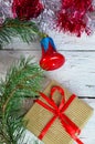 Christmas or new year composition. Christmas gift, two Christmas decorations red blue bell, pine cones, fir branches on Royalty Free Stock Photo