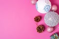 Christmas New Year composition. Gifts, fir tree cones, silver ball decorations on pink background. Winter holidays concept Royalty Free Stock Photo