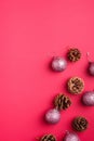 Christmas New Year composition. Gifts, fir tree cones, silver ball decorations on pink background. Winter holidays concept Royalty Free Stock Photo