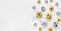 Christmas or New Year composition with gold and silver sparkling ribbon decorations on white background. Flat lay, copy space Royalty Free Stock Photo