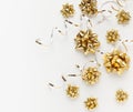 Christmas or New Year composition with gold sparkling ribbon decorations on white background. Flat lay, copy space Royalty Free Stock Photo