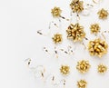 Christmas or New Year composition with gold sparkling ribbon decorations on white background. Flat lay, copy space Royalty Free Stock Photo