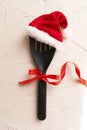 Christmas and new year composition with kitchen tools and Santa hat on grey conctere background. Xmas cooking concept Royalty Free Stock Photo