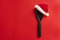 Christmas and new year composition with kitchen tools and Santa hat on red background. Xmas cooking concept. Top view with copy Royalty Free Stock Photo
