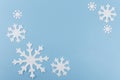 Christmas or New Year composition made of felt snowflakes on blue background. Winter season backdrop with decorative Royalty Free Stock Photo