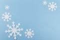 Christmas or New Year composition made of felt snowflakes on blue background. Winter season backdrop with decorative Royalty Free Stock Photo