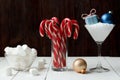 Christmas New Year composition marshmallow and candy stick in glass gifts ball on white wooden table background banner web design Royalty Free Stock Photo