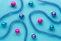 Christmas or new year composition with multicolored balls and tinsel on a blue background