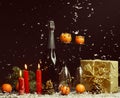 Christmas New Year composition with tangerines and pine cones. Bottle of wine,  red candles, gift box Royalty Free Stock Photo