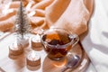 Christmas / New Year composition. Transparent cup of tea, garland, tree, safe candles, tinting. Copy space Royalty Free Stock Photo