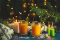 Christmas and New Year composition. Two cup of hot spicy tea with sea buckthorn, cinnamon and star anise, branches of pine and