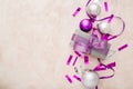 Christmas or New Year composition. Xmas purple and silver decorations: ribbons and balls on pink pastel background. Flat lay, top Royalty Free Stock Photo