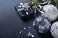 Christmas or New Year concept with black and silver baubles ball, gift box and champagne with decorated silver metallic ribbon on Royalty Free Stock Photo