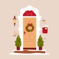 Christmas and New Year concept. Entrance door decorated for Christmas. Traditional Christmas home decoration, fir trees, lantern