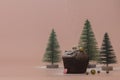 Christmas and New Year concept. Homemade chocolate muffin. Green Christmas trees in the snow on a pink gentle background. Copy