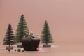 Christmas and New Year concept. Homemade chocolate muffin. Green Christmas trees in the snow on a pink gentle background. Copy