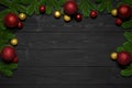 Christmas or New Year dark wood background. Xmas black board framed with season decorations. Copy Space