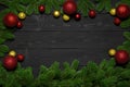 Christmas or New Year dark wood background. Xmas black board framed with season decorations, space for a text, view from above Royalty Free Stock Photo